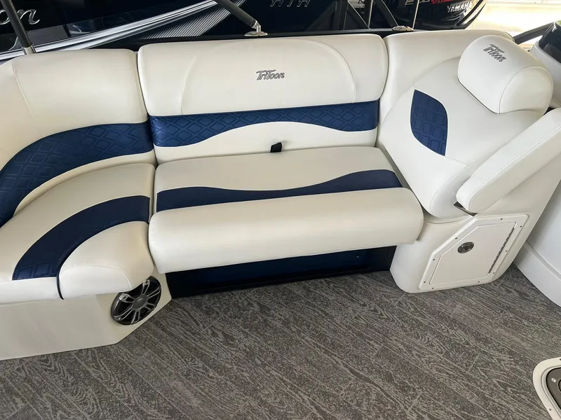 Slide: The Image of Luxurious seating on 2025 JC 21 NEPTOON TT Sport boat, featuring white and blue upholstery. - 6