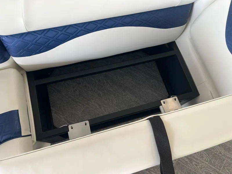Slide: The Image of 2025 JC 21 NEPTOON TT Sport boat seat storage compartment, open with blue and white upholstery. - 7