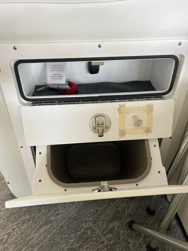 Slide: The Image of Storage compartment in 2025 JC 21 NEPTOON TT Sport boat, featuring secure latch and interior space. - 8