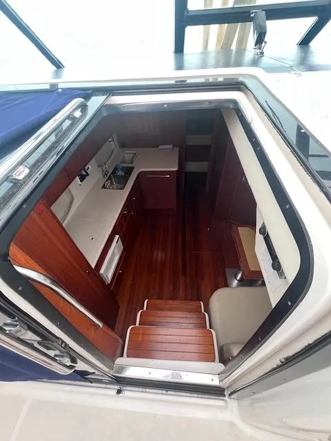 Slide: The Image of Interior view of 2001 Tiara Yachts 3500 Express, showcasing wooden cabinetry and flooring. - 11