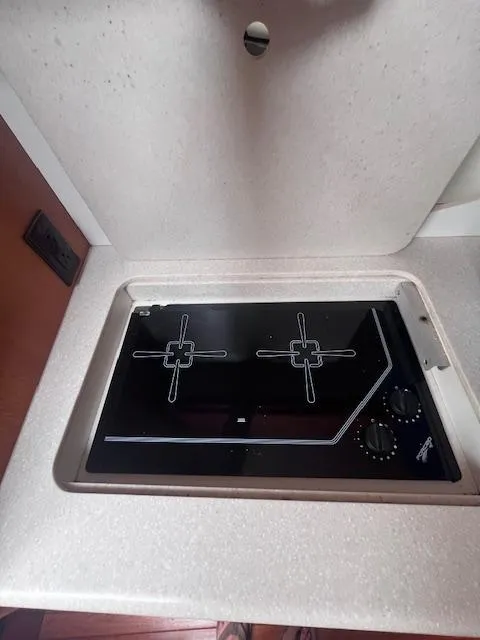 Slide: The Image of 2001 Tiara Yachts 3500 Express stovetop in cabin kitchen area. - 14