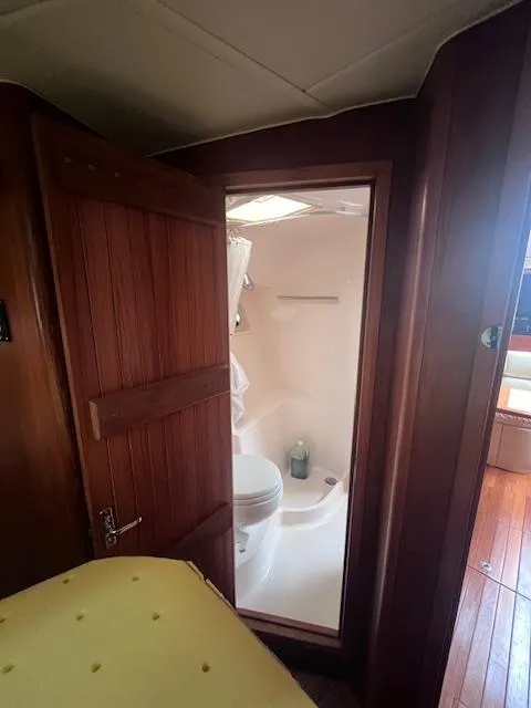 Slide: The Image of 2001 Tiara Yachts 3500 Express bathroom interior with wooden door and compact design. - 17
