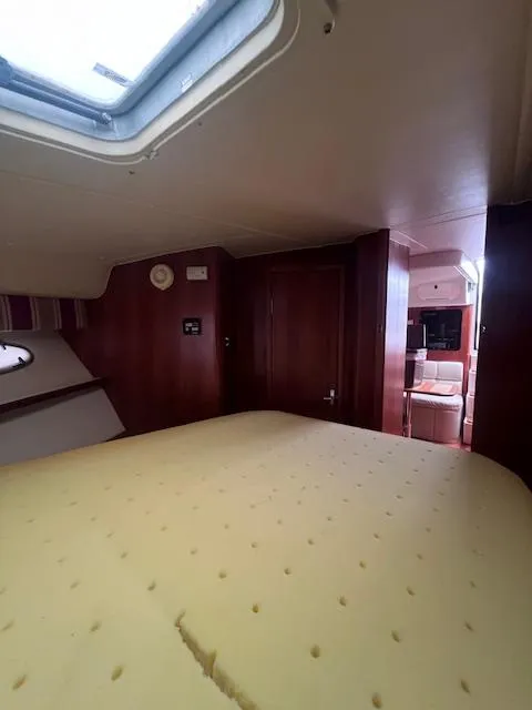 Slide: The Image of Interior cabin of 2001 Tiara Yachts 3500 Express with skylight and cozy furnishings. - 18