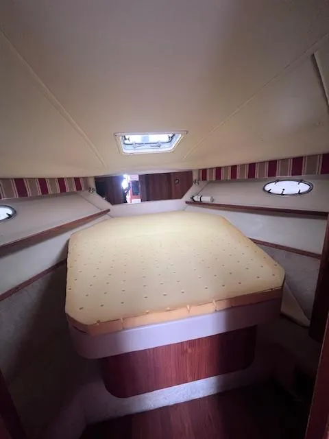 Slide: The Image of 2001 Tiara Yachts 3500 Express cabin interior with bed and portholes. - 19