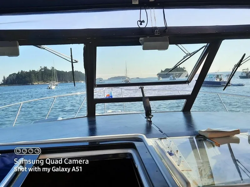 Slide: The Image of View from 2001 Tiara Yachts 3500 Express cockpit, overlooking serene waters and distant boats. - 2