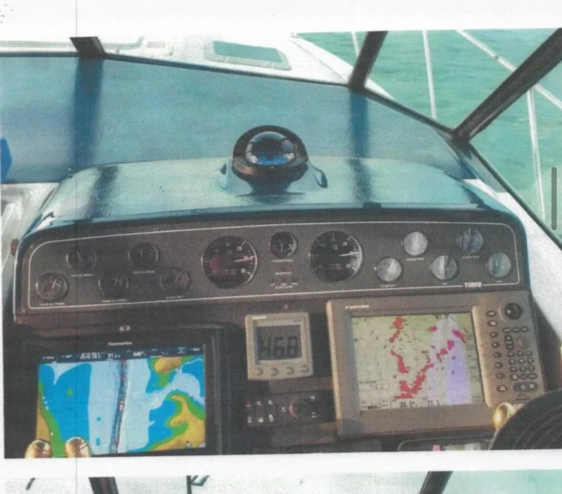 Slide: The Image of Dashboard of a 2001 Tiara Yachts 3500 Express with navigation instruments and displays. - 23