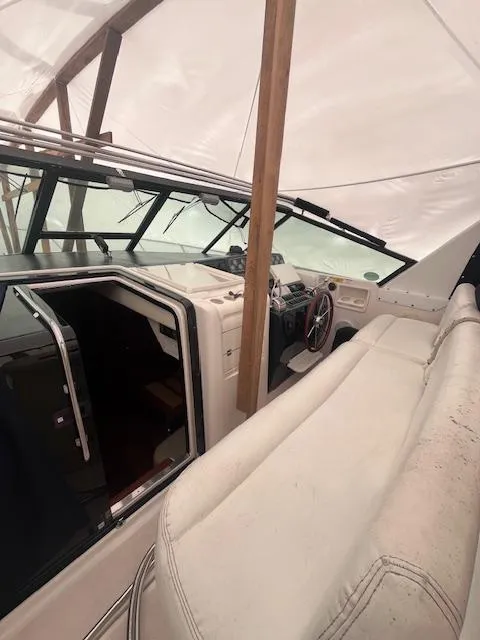 Slide: The Image of 2001 Tiara Yachts 3500 Express interior with helm and seating under cover. - 25