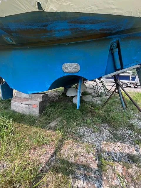 Slide: The Image of 2001 Tiara Yachts 3500 Express boat hull on dry land, blue paint, propeller visible. - 29