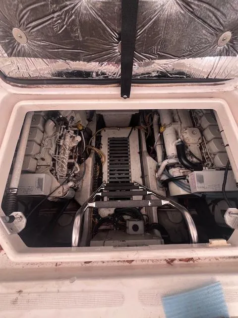 Slide: The Image of Engine compartment of 2001 Tiara Yachts 3500 Express, showcasing dual engines and mechanical components. - 32