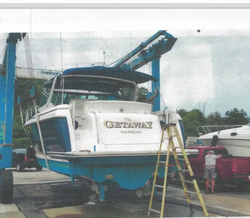 Slide: The Image of 2001 Tiara Yachts 3500 Express on lift, "Getaway" name visible, Baltimore, MD. - 6