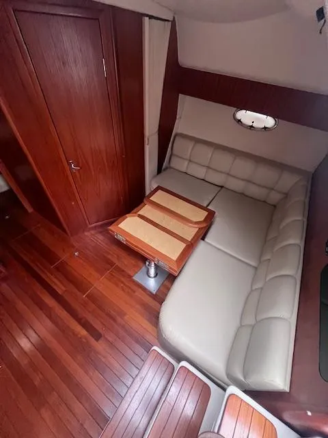 Slide: The Image of 2001 Tiara Yachts 3500 Express interior with wood flooring and leather seating. - 8