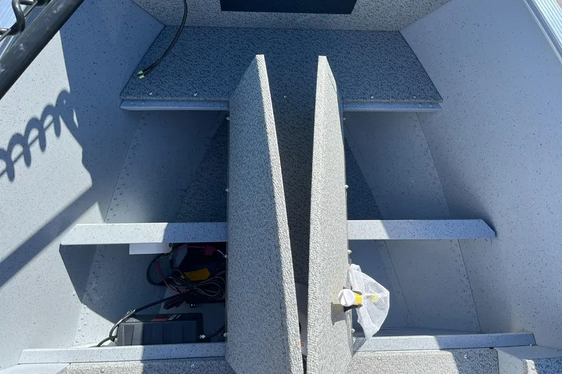 Slide: The Image of 2025 Lund 1600 Fury SS boat interior with storage compartments and equipment. - 12