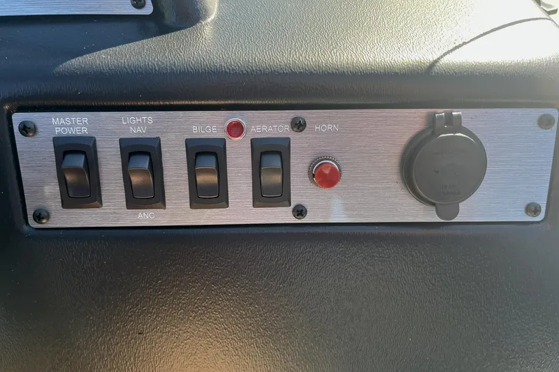 Slide: The Image of Control panel of 2025 Lund 1600 Fury SS boat with switches and buttons. - 21