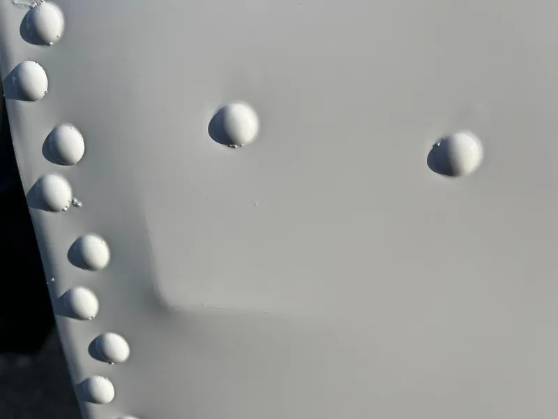 Slide: The Image of Close-up of rivets on 2025 Lund 1600 Fury SS boat hull. - 26