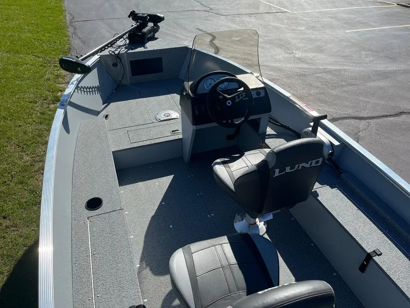 Slide: The Image of 2025 Lund 1600 Fury SS boat interior with steering console and seating. - 7