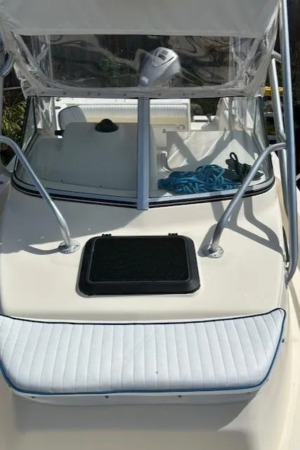Slide: The Image of 2004 Key West 2300 WA boat deck with windshield and blue rope. - 11
