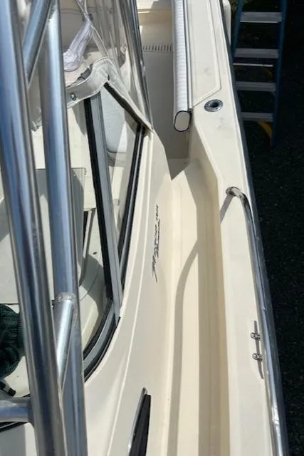 Slide: The Image of 2004 Key West 2300 WA boat, side view with railing and cockpit details. - 14