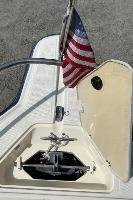 Slide: The Image of 2004 Key West 2300 WA boat anchor compartment with American flag. - 16