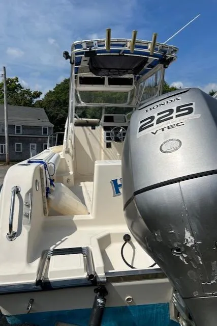 Slide: The Image of 2004 Key West 2300 WA boat with Honda 225 VTEC engine, docked outdoors. - 19