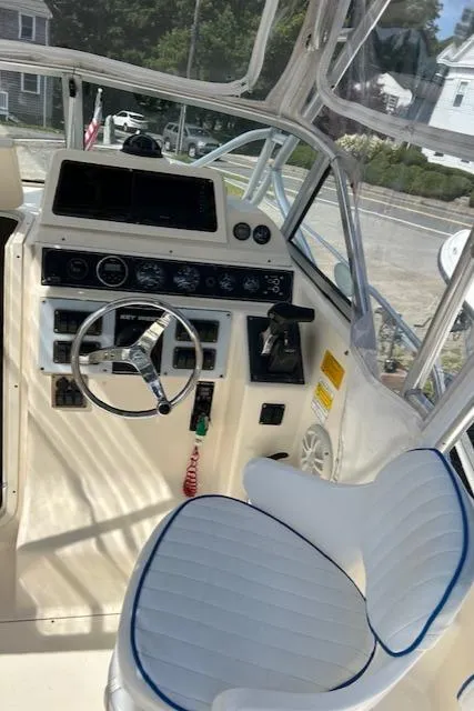 Slide: The Image of 2004 Key West 2300 WA boat cockpit with steering wheel and controls. - 6