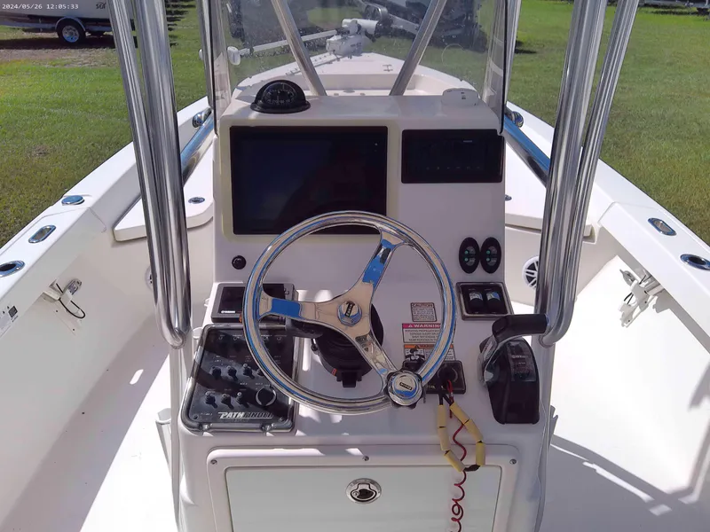 Slide: The Image of 2016 Pathfinder 2400 TRS boat console with steering wheel and navigation controls. - 6