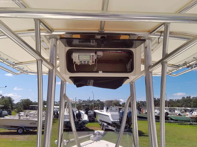 Slide: The Image of 2016 Pathfinder 2400 TRS boat with T-top and electronics, parked in a marina. - 7