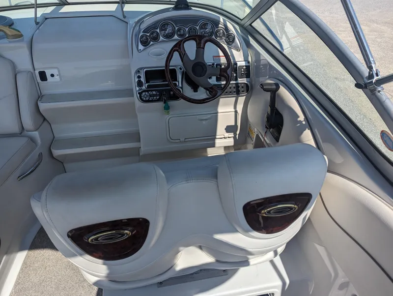 Slide: The Image of 2004 Crownline 250 CR boat interior with steering wheel and dashboard controls. - 15