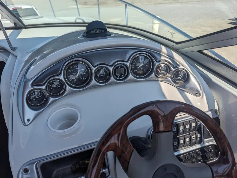 Slide: The Image of Dashboard of a 2004 Crownline 250 CR boat with gauges and steering wheel. - 19