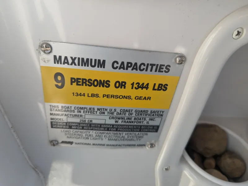 Slide: The Image of Maximum capacity sign on 2004 Crownline 250 CR boat: 9 persons or 1344 lbs. - 22