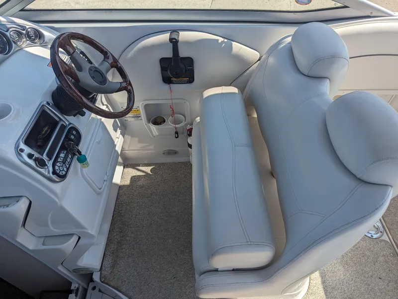 Slide: The Image of 2004 Crownline 250 CR boat interior with steering wheel and seating. - 24