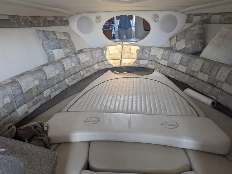 Slide: The Image of Interior of 2004 Crownline 250 CR boat with cushioned seating and oval window. - 26