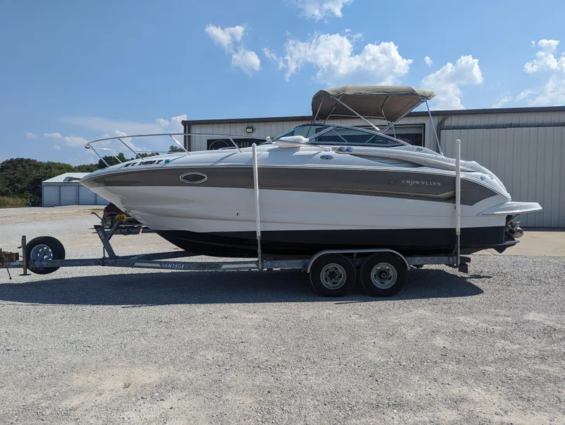 Slide: The Image of 2004 Crownline 250 CR boat on trailer, parked outdoors under a clear sky. - 3