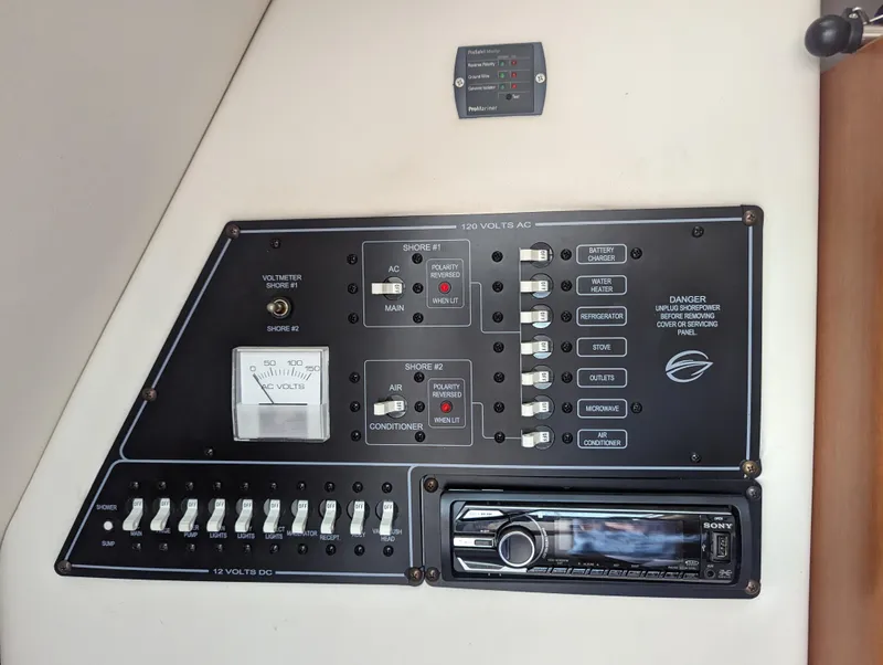 Slide: The Image of Control panel of a 2004 Crownline 250 CR boat, featuring switches and a stereo system. - 31