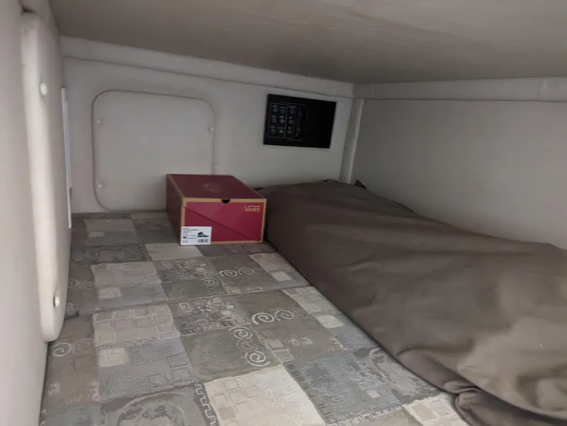 Slide: The Image of 2004 Crownline 250 CR cabin interior with patterned flooring and a red box. - 33