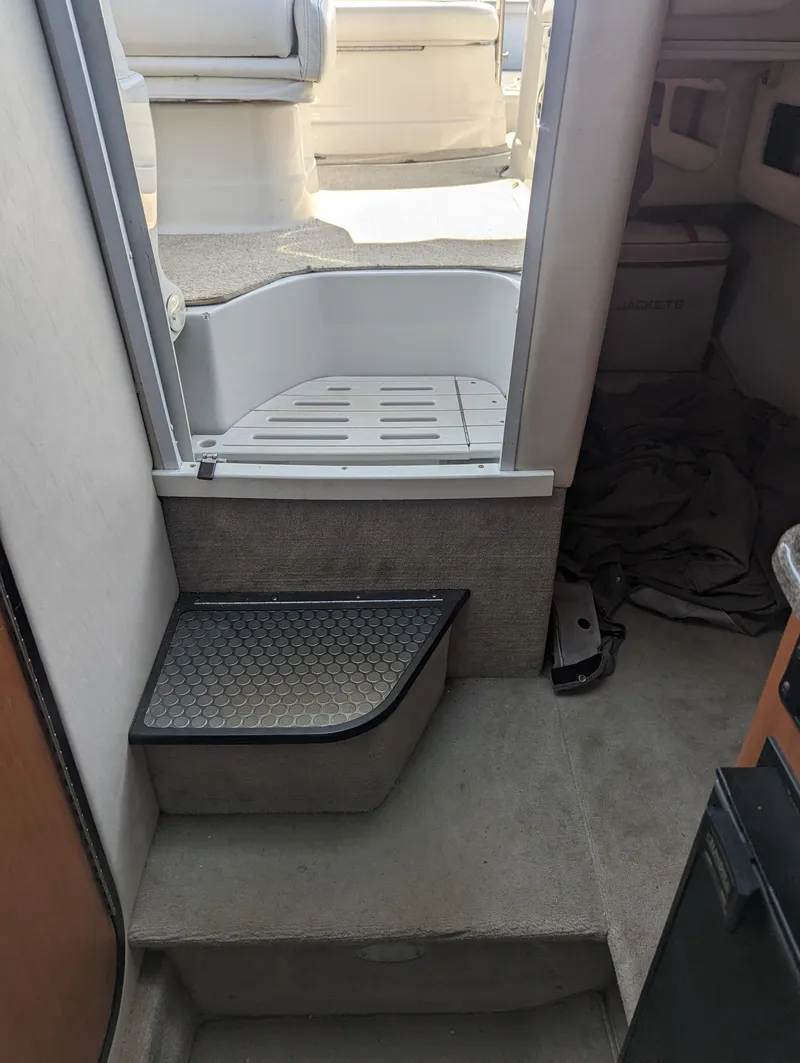 Slide: The Image of Interior view of 2004 Crownline 250 CR boat, showing steps and seating area. - 36