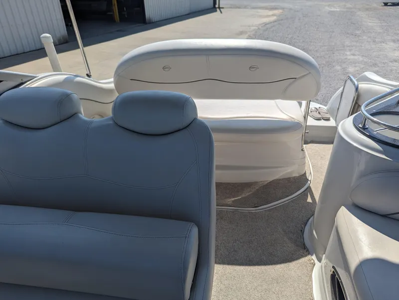 Slide: The Image of 2004 Crownline 250 CR boat interior with white seating and steering area. - 37