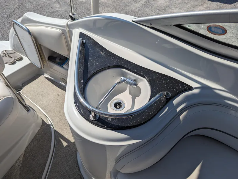 Slide: The Image of 2004 Crownline 250 CR boat interior with a sleek sink and faucet setup. - 38