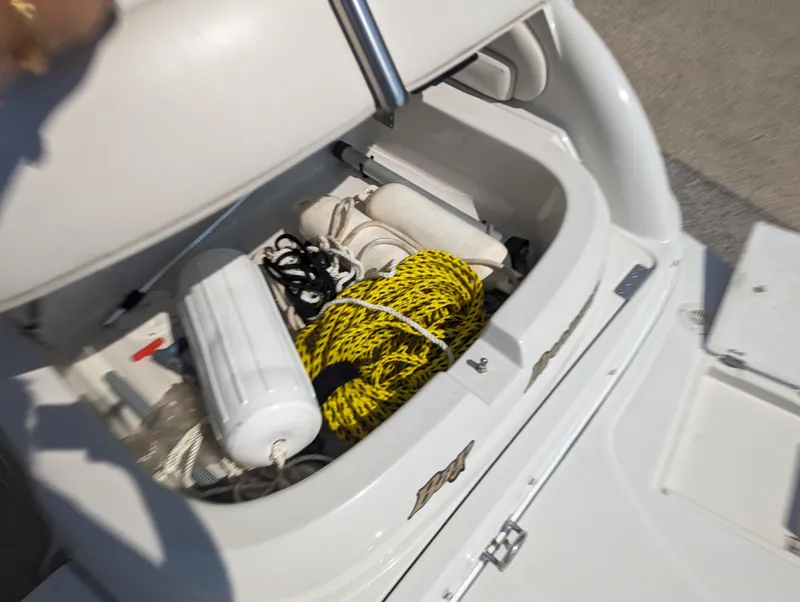 Slide: The Image of Storage compartment of a 2004 Crownline 250 CR boat with ropes and fenders. - 40