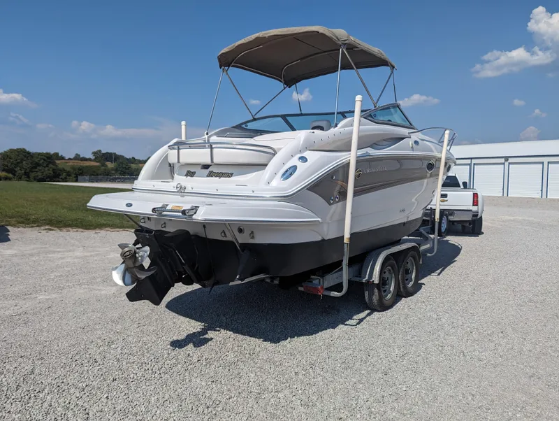 Slide: The Image of 2004 Crownline 250 CR boat on trailer, parked outdoors under clear sky. - 5