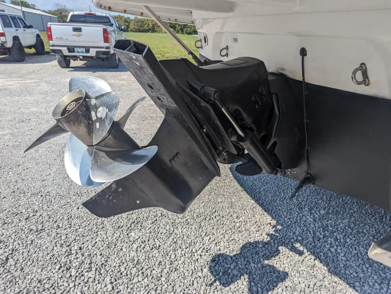 Slide: The Image of 2004 Crownline 250 CR boat propeller and stern drive on gravel surface. - 6