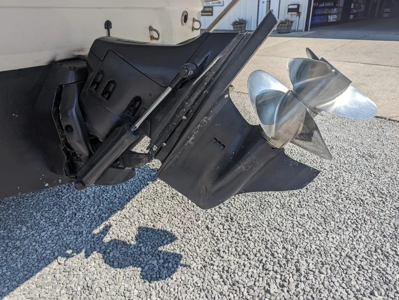 Slide: The Image of 2004 Crownline 250 CR boat propeller and outdrive on gravel surface. - 7