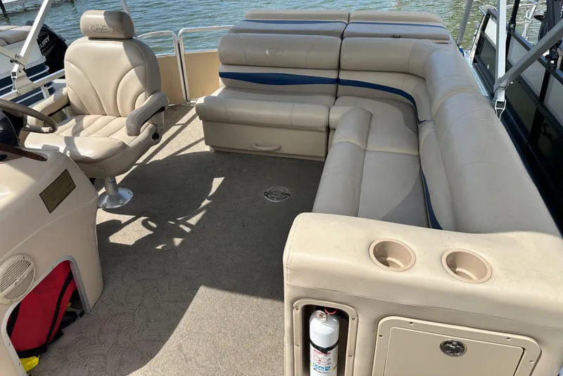 Slide: The Image of 2005 Harris FloteBote Sunliner 200 pontoon boat interior with beige seating and steering console. - 16