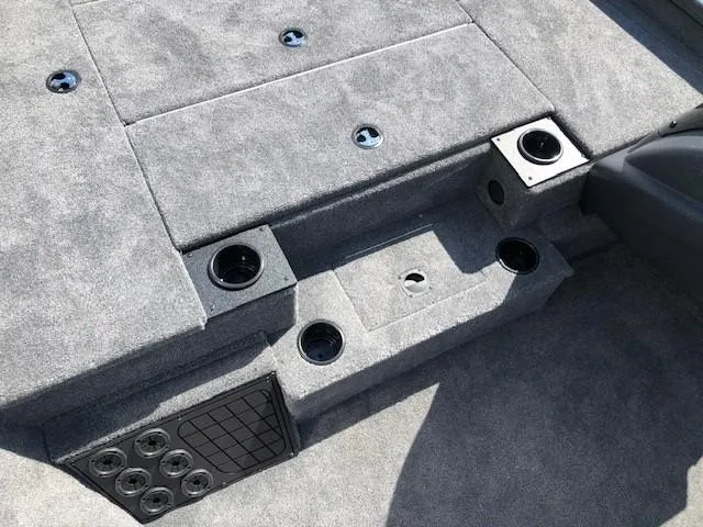 Slide: The Image of 2025 Tracker Pro Team 195 TXW Tournament Edition boat interior with carpeted deck and cup holders. - 11