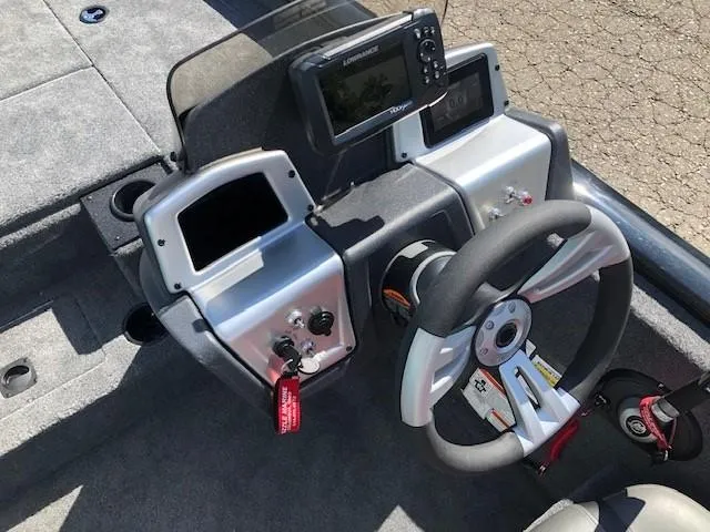 Slide: The Image of 2025 Tracker Pro Team 195 TXW Tournament Edition boat dashboard with steering wheel and controls. - 17