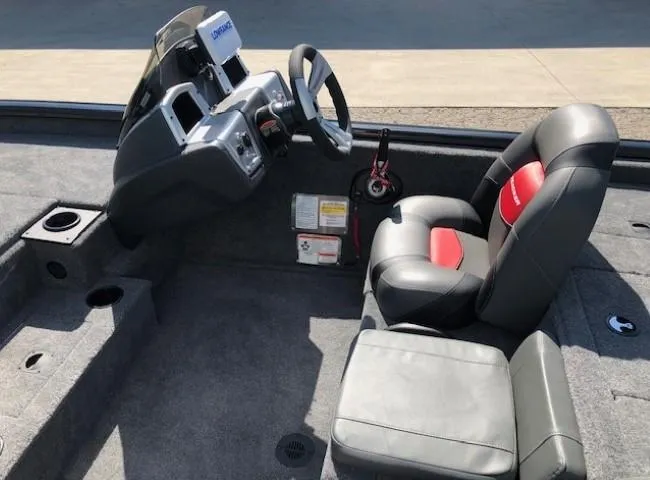Slide: The Image of 2025 Tracker Pro Team 195 TXW Tournament Edition boat interior with steering console and seating. - 18