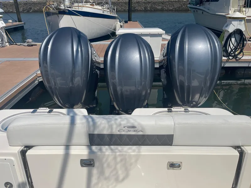 Slide: The Image of 2022 Cobia 350 boat with triple outboard engines docked at marina. - 10