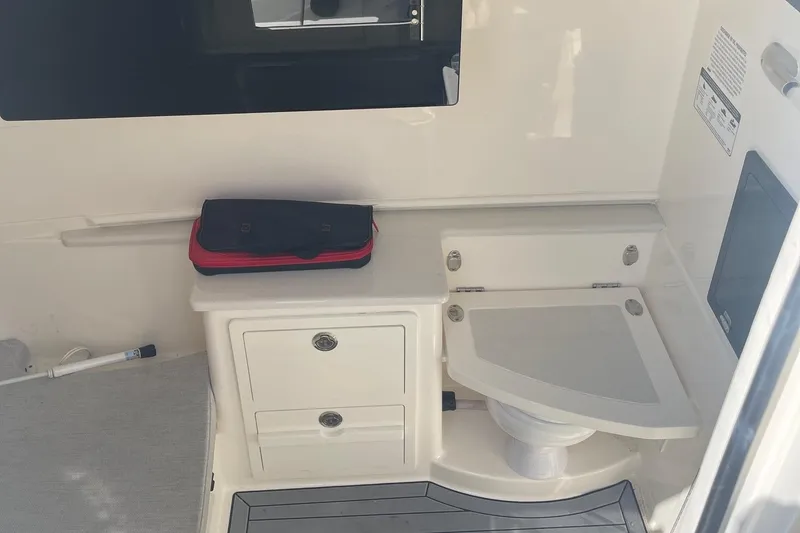 Slide: The Image of 2022 Cobia 350 boat interior with storage and seating area. - 12