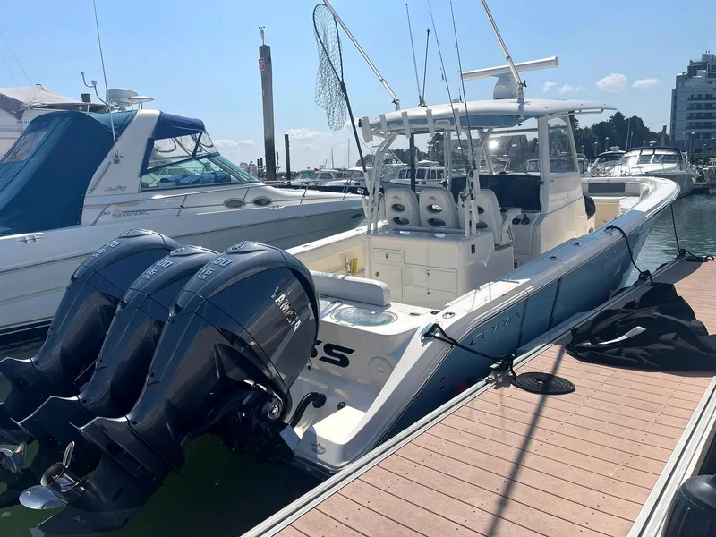 Slide: The Image of 2022 Cobia 350 boat docked with triple outboard engines. - 3