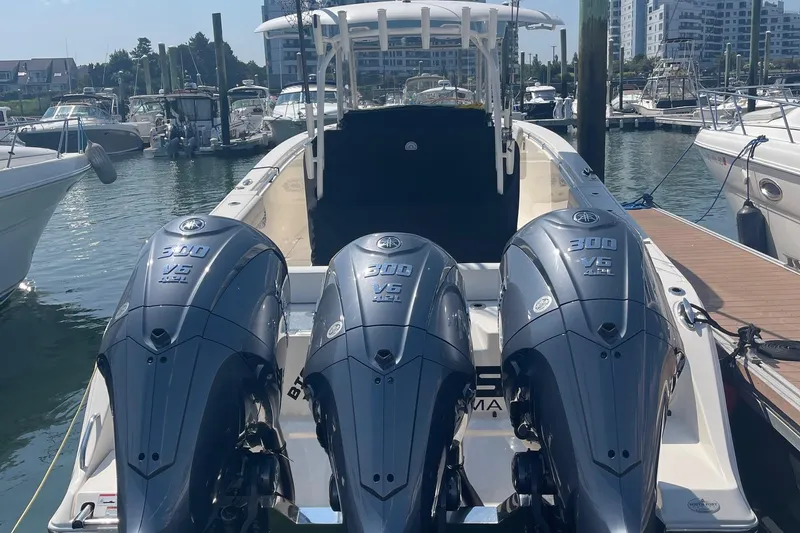 Slide: The Image of 2022 Cobia 350 boat with triple Yamaha 300 engines docked at marina. - 5