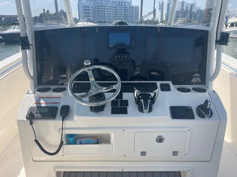 Slide: The Image of 2022 Cobia 350 boat dashboard with steering wheel and navigation controls. - 7